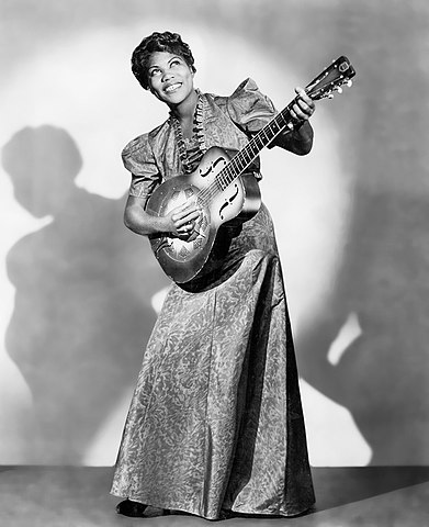 Photo of Sister Rosetta Tharpe playing guitar.